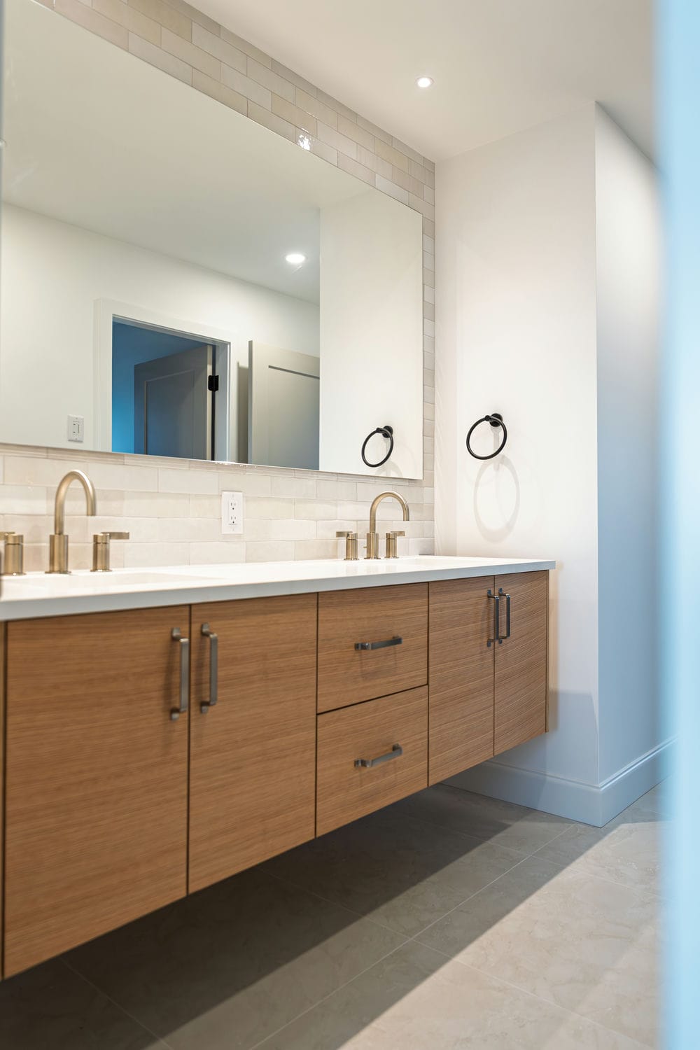 Custom bathroom with freestanding tub and dark tile